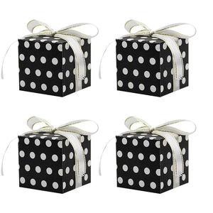 Set of 4 black gift boxes with white polka dots and decorative gold-edged ribbons