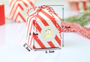 Detail van rood gestreepte kerst snoepdoos met goud nummer 2 en wit-rood katoenen touwtje