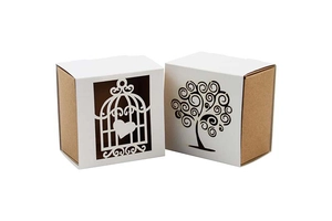 Laser-cut white and kraft paper wedding gift boxes with birdcage and tree hollow designs