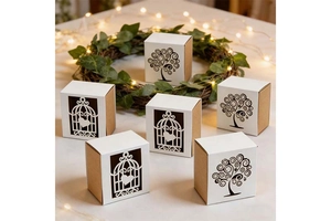 Detail of tree of life and birdcage laser-cut hollow kraft paper candy gift boxes