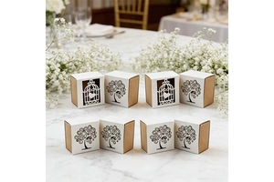 Close-up of European style hollow birdcage and tree of life wedding candy boxes