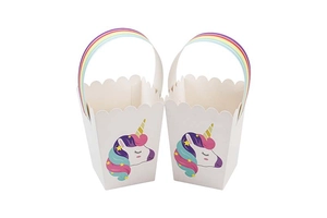 Detail of cute unicorn party gift boxes with rainbow handles and wavy scalloped edges