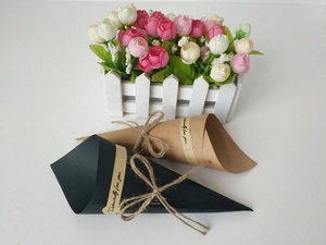 Macro shot of kraft paper flower bouquet cones with twine ties and decorative stickers