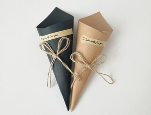 Detail of cone-shaped kraft paper gift boxes with jute twine bows and stickers