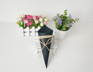 Conical black kraft paper flower gift wrap box with rustic jute bow and greeting sticker