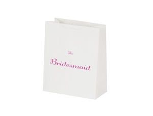 Close-up of white paper gift bag with pink The Bridesmaid script lettering for weddings