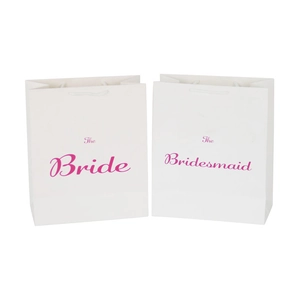 White wedding gift bags with pink The Bride and The Bridesmaid text for bridesmaids