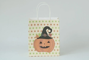 Detail of Halloween pumpkin paper gift bag with polka dots and wizard hat design