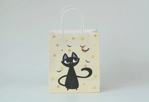 Detail of Halloween kraft paper bag featuring cartoon black cat and moon illustration