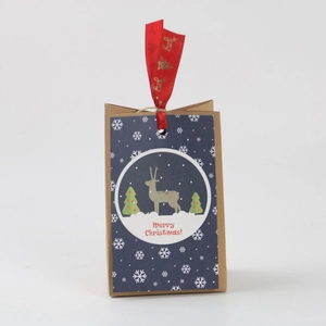 Christmas kraft paper gift bag featuring blue reindeer design and festive red ribbon handle