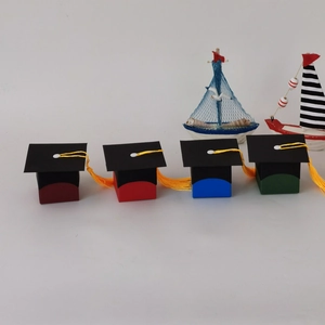 European style graduation cap candy boxes in red, blue, and green with golden tassels