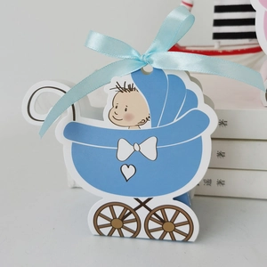Detail of blue baby stroller gift box with white bow and heart pattern decoration