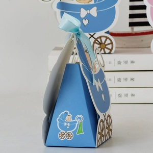 Detailed view of light blue baby carriage candy box with ribbon bow and thanks tag