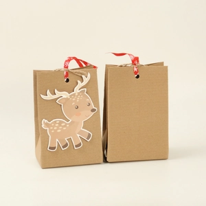 Brown kraft paper Christmas gift bags featuring a cute deer patch and red snowflake ribbons
