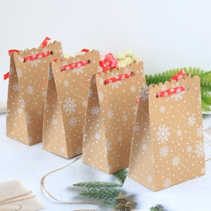 Set di 4 sacchetti regalo di Natale in carta kraft con fiocchi di neve e nastri rossi