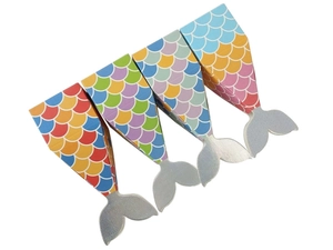 Detail of four colorful mermaid tail candy boxes with scale patterns and silver fins