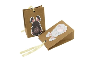 Detail of kraft paper Easter bunny gift bags with corrugated texture and ribbon handles