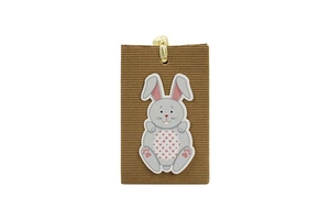 Detailed view of a brown kraft paper gift bag with a cute bunny sticker and gold fastener