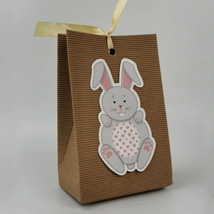 Easter bunny kraft paper gift bag with cute rabbit cutout and yellow ribbon bow decoration