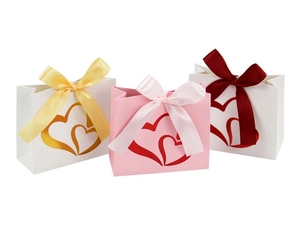 Detailed view of three gift bags featuring gold stamped double hearts and satin ribbons