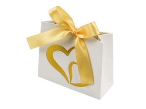 Detail of white gift bag with golden double heart and shiny satin ribbon bow