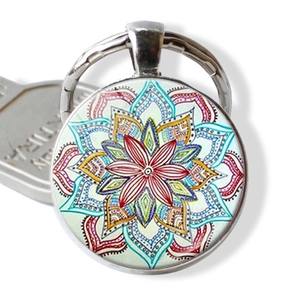 Artistic mandala yoga keychain with colorful glass gem pendant on white background