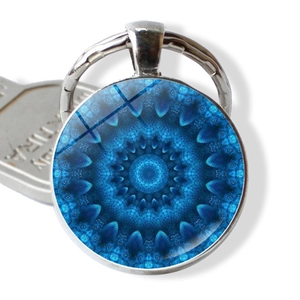 Macro shot of blue mandala pattern cabochon pendant with silver metal keyring