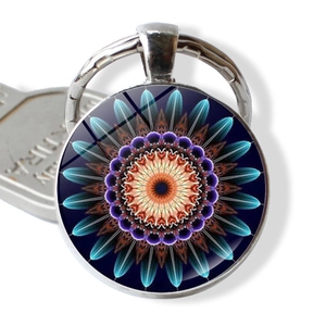 Macro detail of mandala glass cabochon keychain with vibrant symmetrical flower pattern