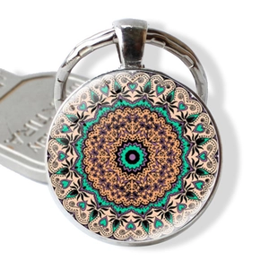Macro view of a mandala glass pendant keychain with silver metal ring and key