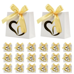 Set of 20 white paper gift bags with gold heart cutouts and yellow silk ribbons
