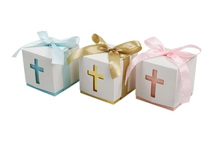 Detailed view of hollow cross gift boxes in blue, gold and pink with ribbon bows