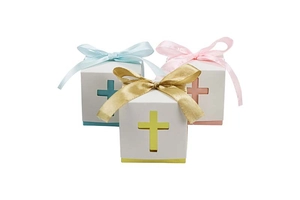 Detail of hollow cross candy boxes in blue, pink, and gold with matching ribbon bows
