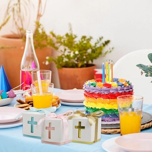 Detail of hollow cross gift boxes with ribbons for wedding and baptism party favors