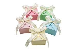 Square macaron-colored gift boxes with elegant white bows and wavy edge design