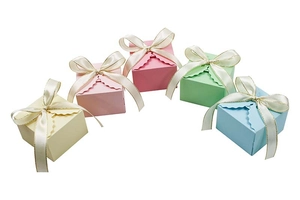 Detail of square candy gift boxes with scalloped edges and gold-trimmed satin bows