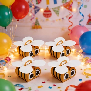 Bee-shaped gift boxes with wing handles set in a festive party scene for candy
