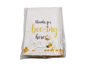 Detail of stacked bee theme gift bags with thanks for bee-ing here text in plastic wrap