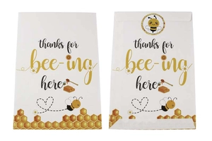 Detail of bee-themed party gift bags with circular sealing stickers and honey motifs
