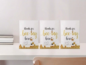 Close-up of three honey bee party gift bags with Thanks For Bee-ing Here design