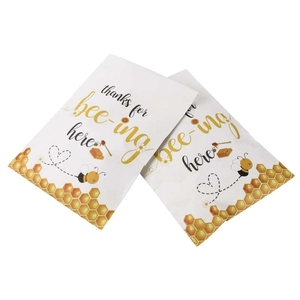 Bee-themed party gift bags with honeycomb pattern and Thanks for Bee-ing Here slogan
