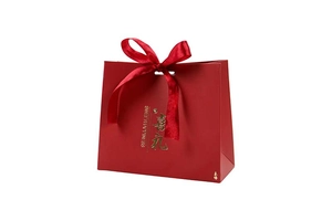 Close-up of red wedding gift box with gold foil lettering and a satin ribbon bow