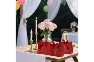 Close-up of red wedding gift bags with gold embossing and elegant silk ribbon bows