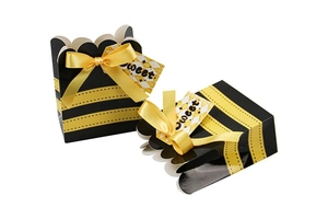Close-up of yellow striped bee theme candy gift box with silk bow and Sweet tag