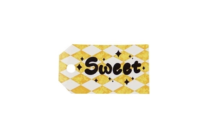 Detail of yellow and white rhombus tag with Sweet lettering and precut hanging hole