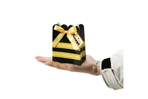 Detail of honeybee stripe candy box with yellow ribbon and 'Sweet' tag for party favors