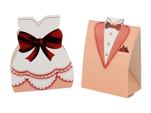 Detailed view of pink tuxedo and white gown paper candy boxes for wedding guest favors
