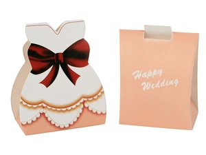 Detail of pink pillow candy box and white bride dress gift box with Happy Wedding text