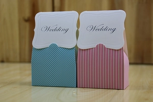 Detail of blue polka dot and pink striped paper wedding gift boxes with Wedding tags