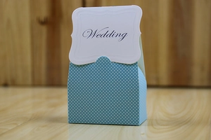 Close-up of light blue polka dot wedding candy box with a decorative Wedding card