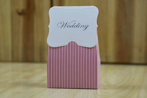 Detail of pink and white striped wedding candy box with a decorative Wedding font flap